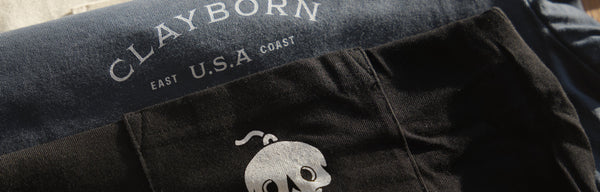 Clayborn T-Shirts Stacked on a Table