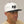 Alpine Crow Snapback Hat with a white crown and black bill on the head of a man looking to the side. 