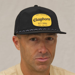 Black Marigold Patch Cap with the person wearing it looking straight on. 